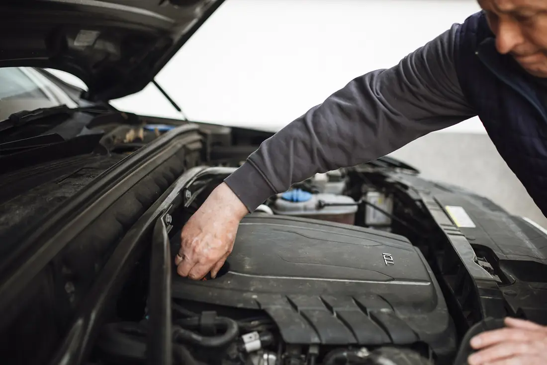 Mechanic inspecting under the hood